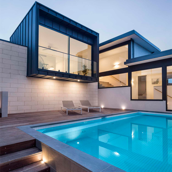 above ground mini pool at night by Inspired Landscapes