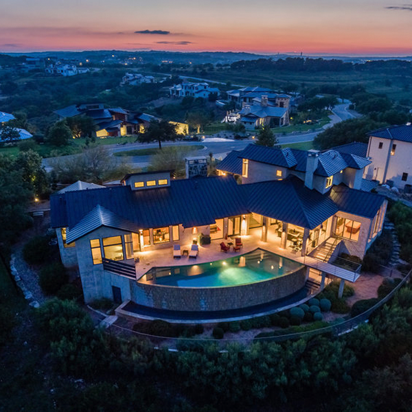 drone view of a custom infinity pool at night, by Modern Design+Build