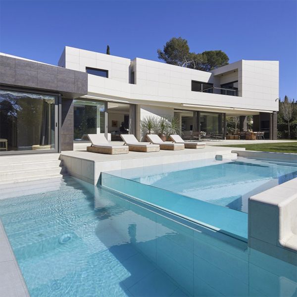 custom pool on two levels with a transparent wall in a project by GAAB Arquitectes