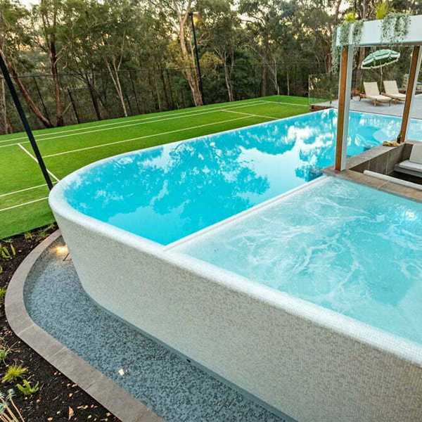 different overflow pool with spa by Striking Pools