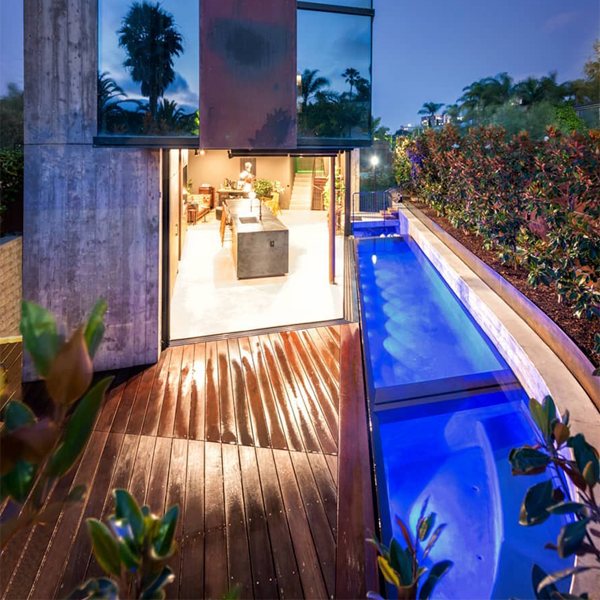 luxury custom infinity pool and spa at night by Babcock (Design my pool)