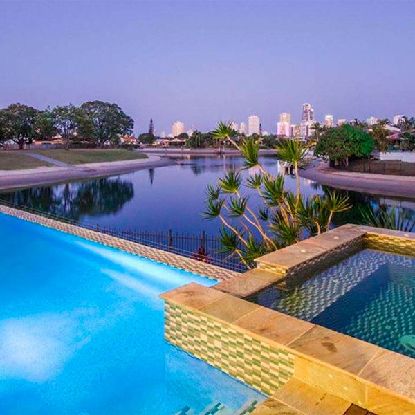 infinity pool and spa at night, by Bali Pools