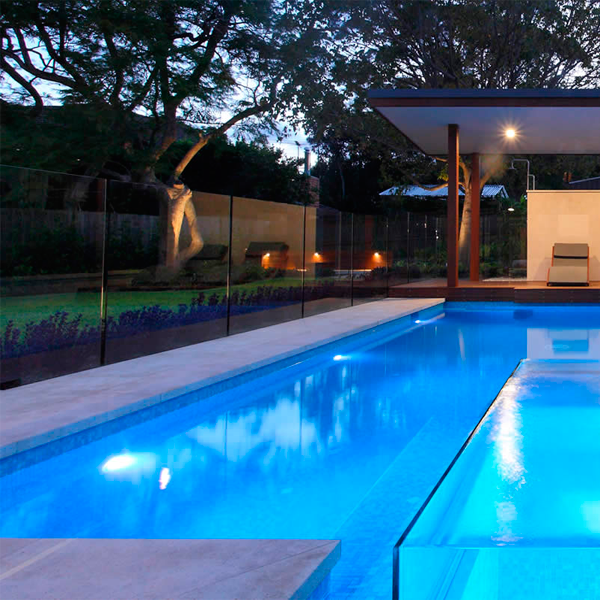 transparent spa overflowing a swimming pool