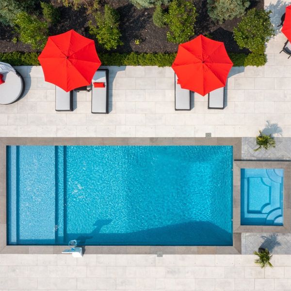 drone view of a classic rectangular pool design and spa, by Aqua Spa Pools