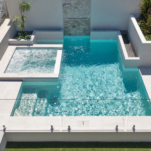 Custom mini pool, with a design based on different straight lines, and integrated overflow spa, by Queensland Family Pools and Spas
