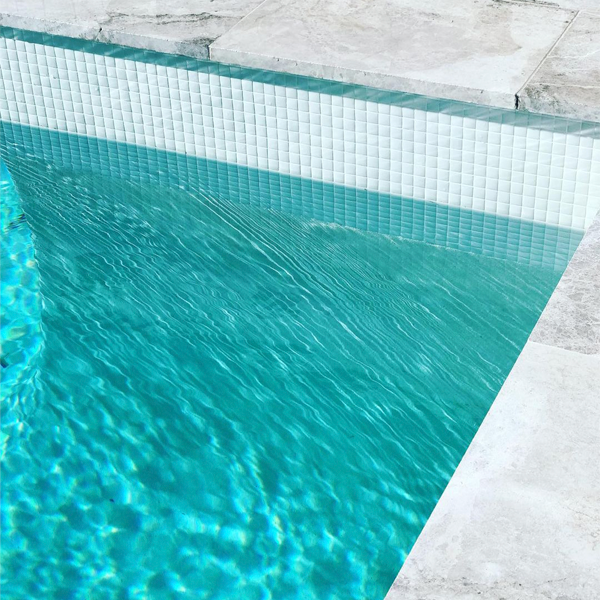 mini pool and spa with transparent wall and white tiles by MG Pools