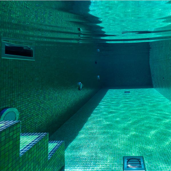 underwater view of a bright tile private pool by Aquaria Pools