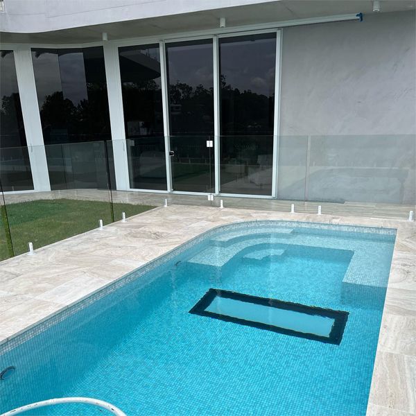 private custom pool with underwater windows in the floor, by Dreamscape Pools and Landscaping