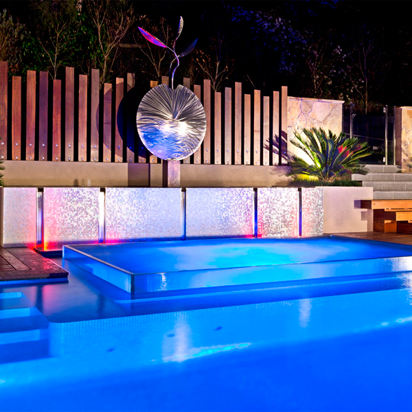 lap infinity pool and spa at night by Justine Carlile