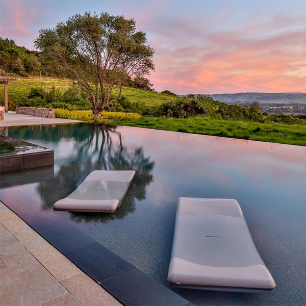 infinity pool and spa at sunset, by Roche and Roche Landscape Architecture