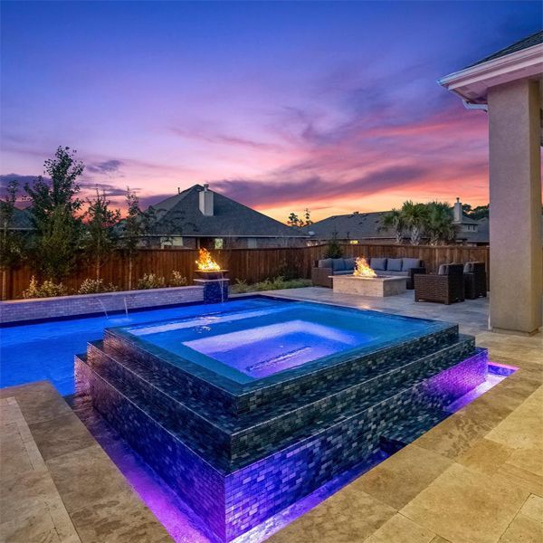 private pool and hot tub lighted at night, by Backyard Oasis
