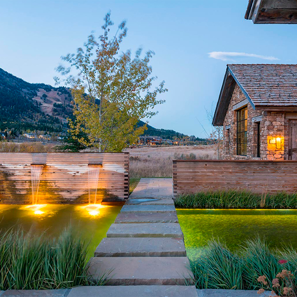 natural pool and landscaping at night by Verdone Landscape Architects