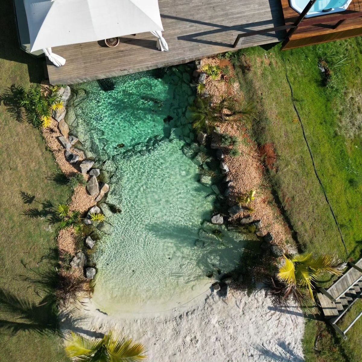 Drone view of a beach-style biological pool project, by Life Ecossistemas, for Casa Grand Valley