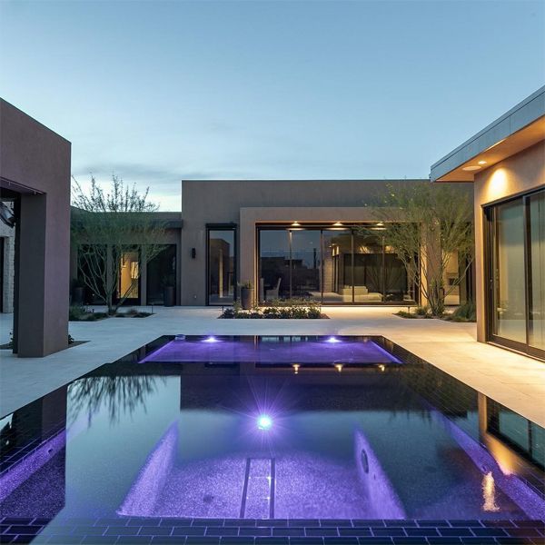 black mirror pool and spa at night, by Flowing Wells