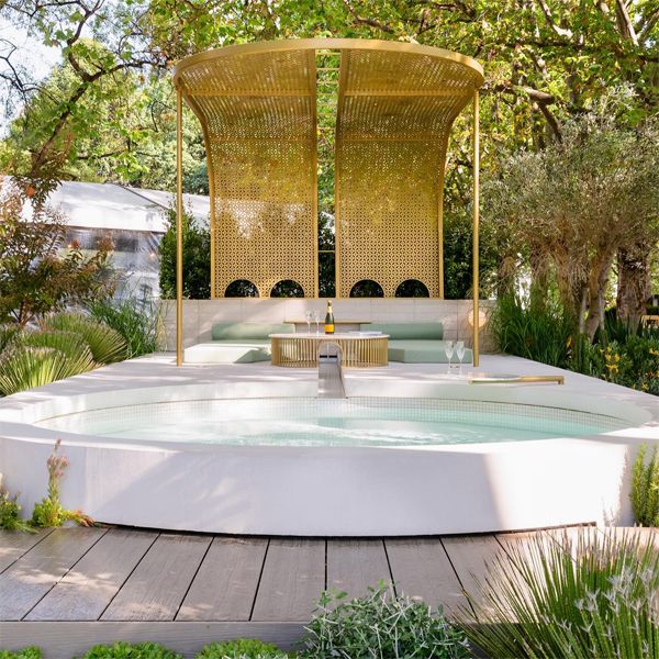 Custom white plunge pool with a modern and refined rounded design, by TLC Pools in a luxury landscaping project with a golden pergola