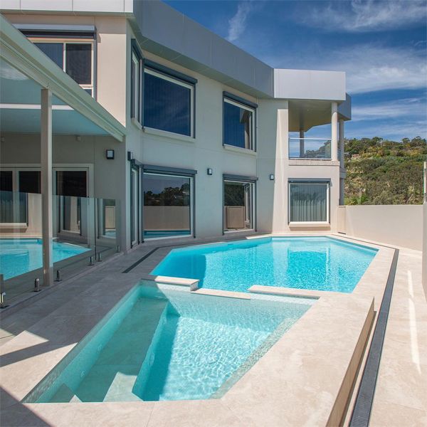 custom pool and spa, with a bright white glass mosaic coating, by Adelaide Classic Pools