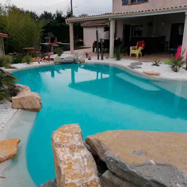 Custom lagoon pool and landscaping in a private garden, by Piscines HDP