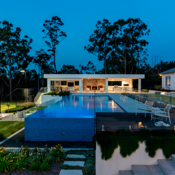 pool and landscape design at night by Rolling Stones Landscapes