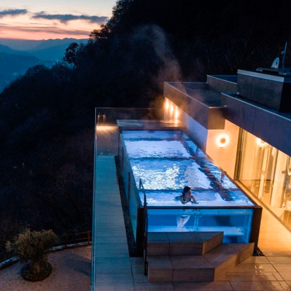 infinity transparent pool by acquaplan at night