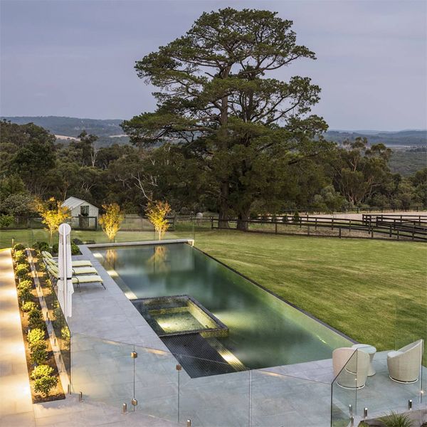 drone view of an infinity lap pool and spa, by Apex Pools and Spas, at sunset