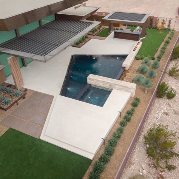 drone view of custom infinity pool with spa by Ozzie Kraft