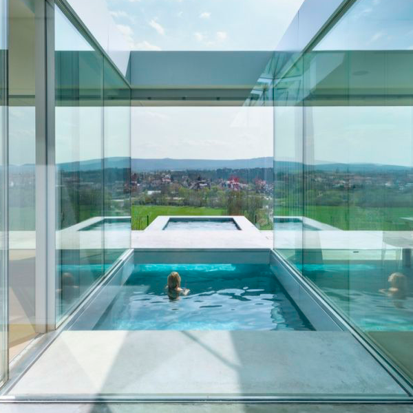 concrete above ground pool surrounded by glass