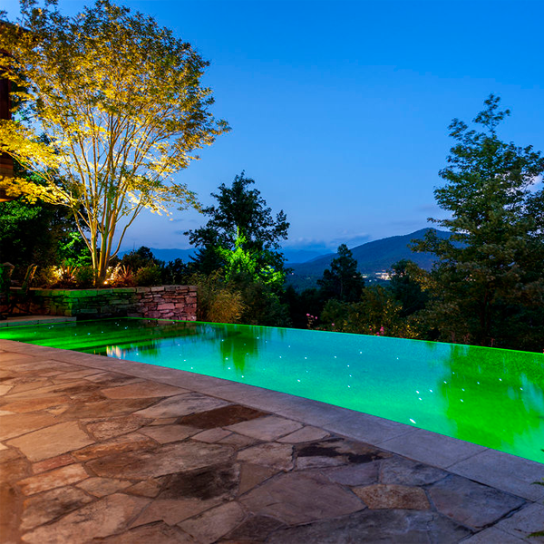 Lighted infinity swimming pool at night