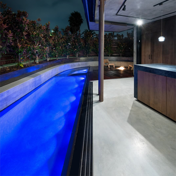 luxury custom infinity pool and spa at night by Babcock (Design my pool)