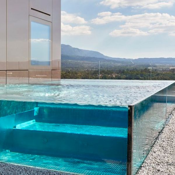 steel infinity pool with transparent walls built in a rooftop, by Nicollier Group