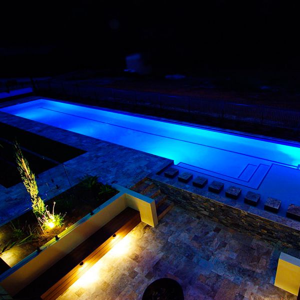 custom lap pool at night, by Cityscapes Pools and Landscapes