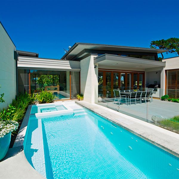 white custom pool with spa, by Icon Pools