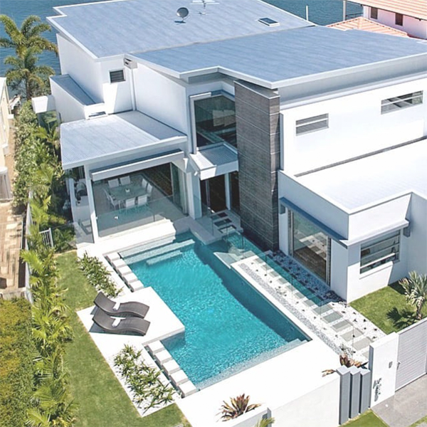 modern swimming pool and house drone view