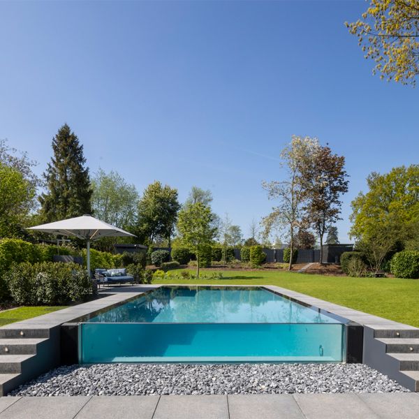infinity pool with transparent wall, by Weidner Pools