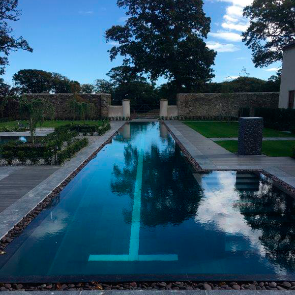 piscina con una calle para natación en jardín con zona spa independiente