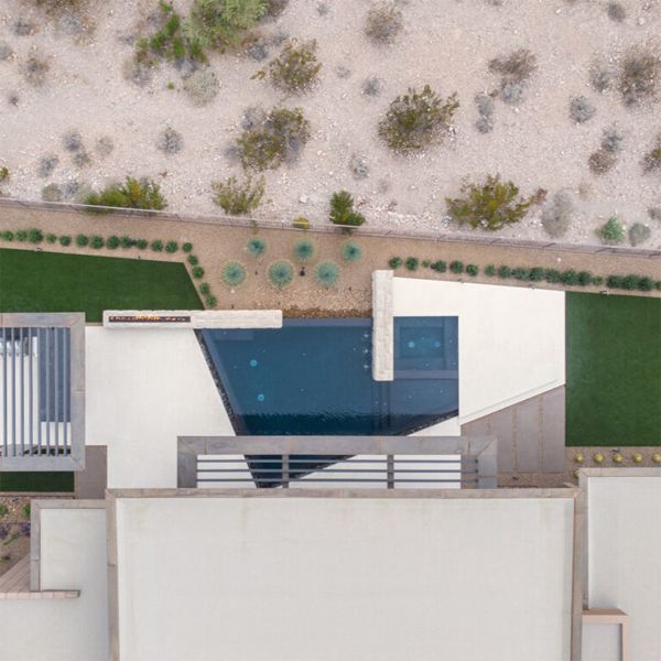 drone view of custom infinity pool with spa by Ozzie Kraft