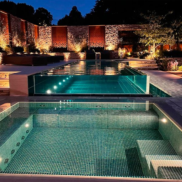 transparent infinity pool and private spa at night by Guncast