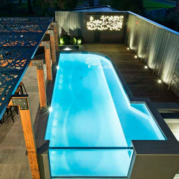 above ground pool with an undewater window by Enki Pools