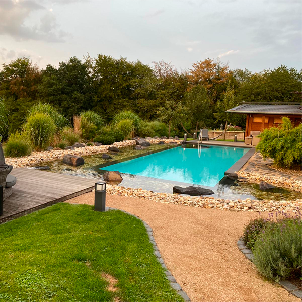 pool surrounded with stones by Gartengestaltung Porten