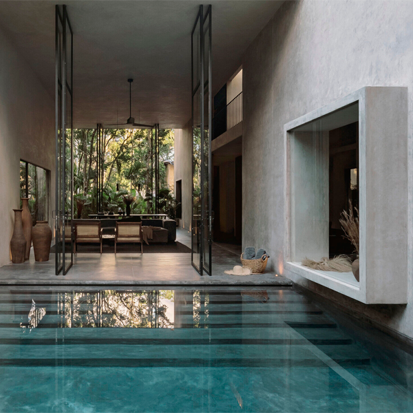 design home from the overflow pool by Co-Lab