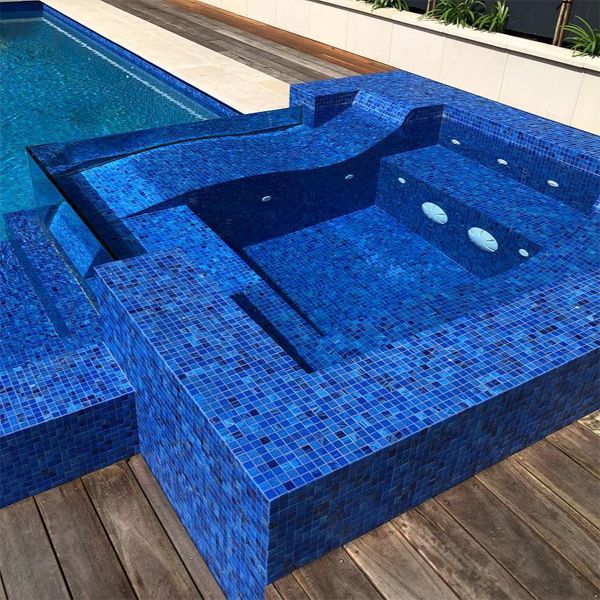 deep blue glass mosaic tile as coating in a spa with transparent walls, by Senator Pools