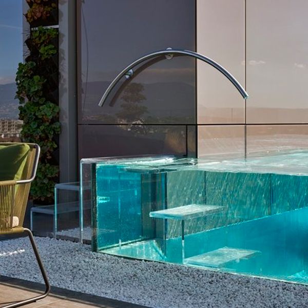 steel infinity pool with transparent walls built in a rooftop, by Nicollier Group