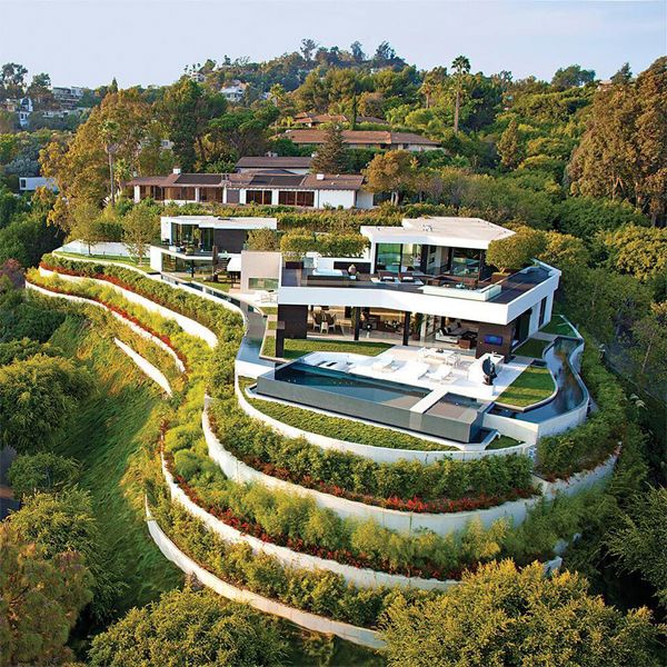 drone view of an impressive pool project around the whole modern house, with overflowing, transparent windows, spa space...by Whipple Russell Architects