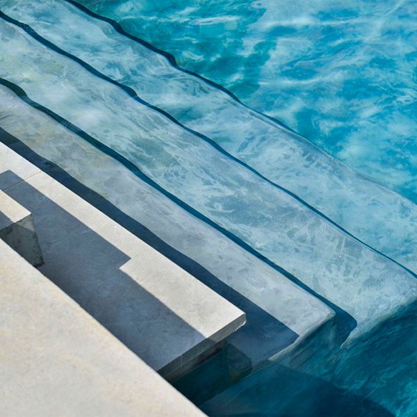 interior steps in a pool by Piscines Jacques Brens
