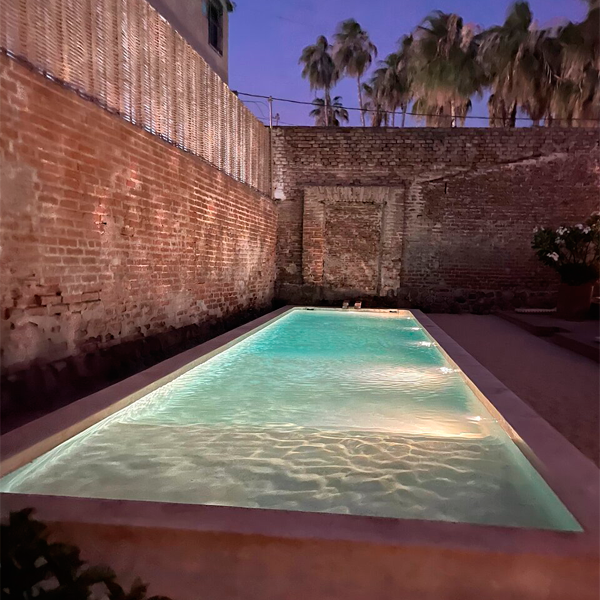 rectangular pool at Baja Club Hotel at night by Max Von Werz