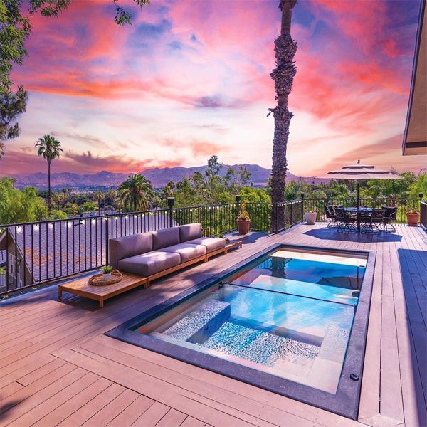 mini container pool with integrated spa space, separated by a transparent underwater window, by Precision Landscaping, at sunset