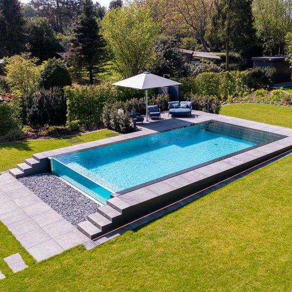 drone view of an infinity pool with transparent wall, by Weidner Pools