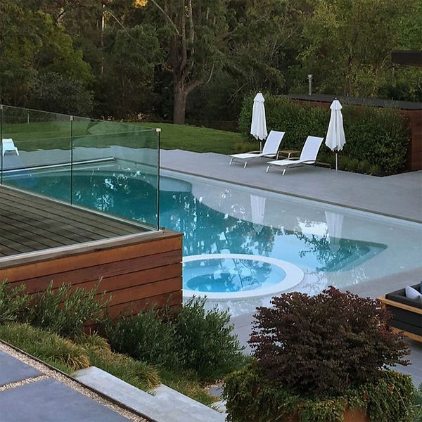 modern white pool with spa, in a project by Greenblott Design