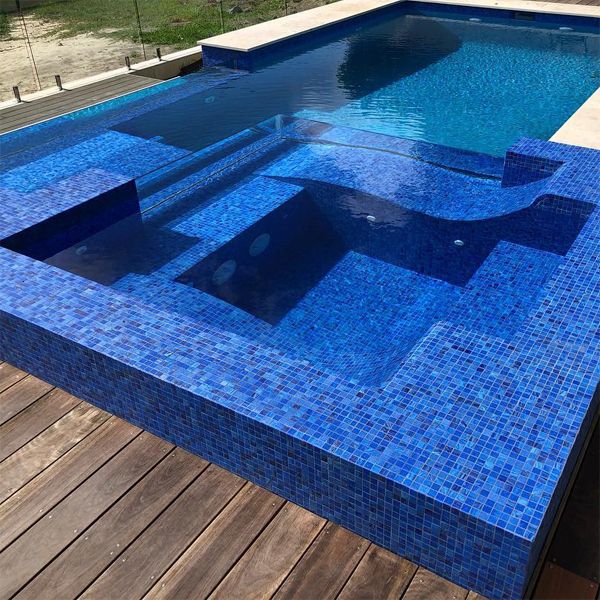infinity spa hot tub built in a mini pool with deep blue glass mosaic tile, by Senator Pools
