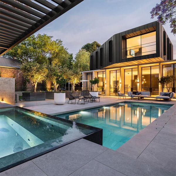 modern minimalist pool and infinity spa in contrast, by Aquacon Pools, at night