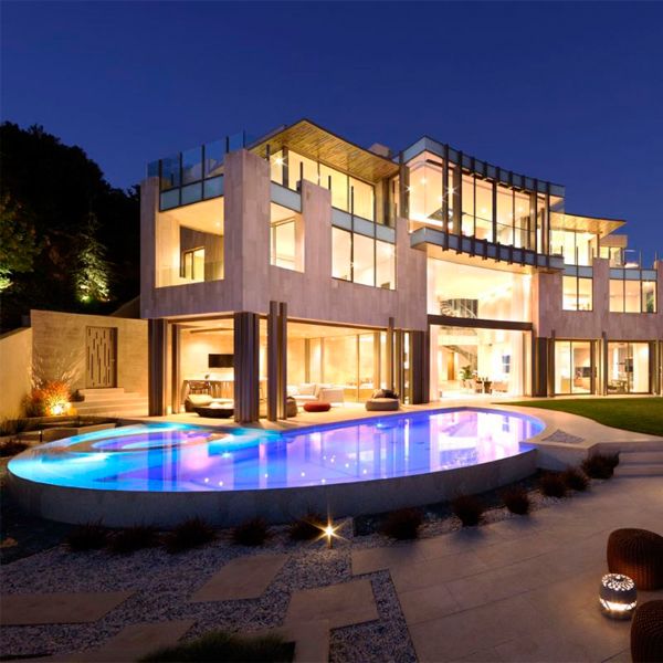 custom infinity pool with built-in spa at night, in a project by Landry Design Group